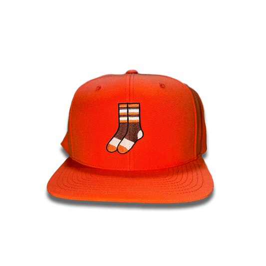 Orange hat with two striped socks in cleveland brown and orange color